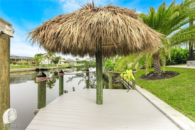 dock area featuring a yard and a water view