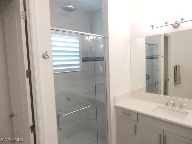 bathroom featuring vanity and an enclosed shower