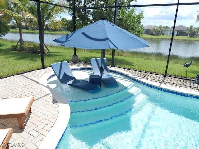 view of pool with a yard, a patio, and a water view