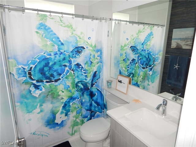 bathroom featuring toilet and vanity