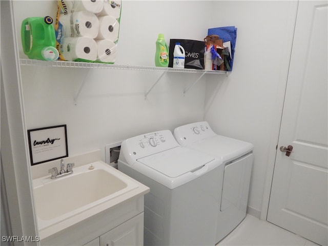 clothes washing area featuring sink and washing machine and dryer