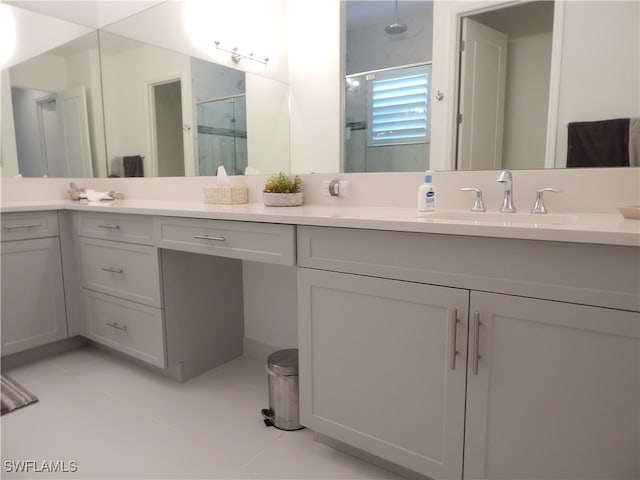 bathroom featuring vanity, an enclosed shower, and tile patterned floors