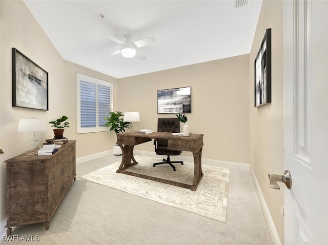 office space featuring ceiling fan and light colored carpet