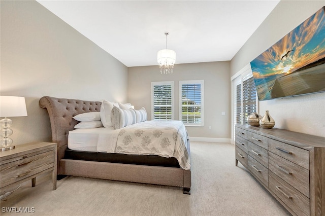 bedroom with light carpet and a chandelier