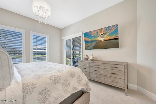 carpeted bedroom with a notable chandelier