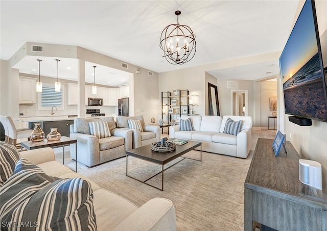 living room featuring a notable chandelier and sink