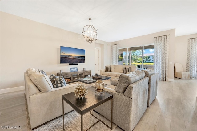 living room featuring light wood-type flooring and a notable chandelier