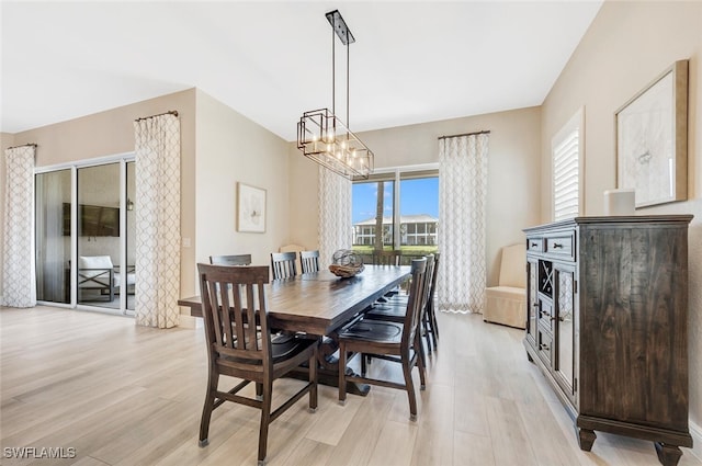 dining room featuring a notable chandelier and light hardwood / wood-style floors