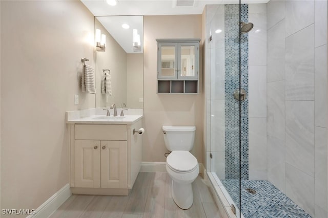 bathroom with an enclosed shower, toilet, hardwood / wood-style flooring, and vanity