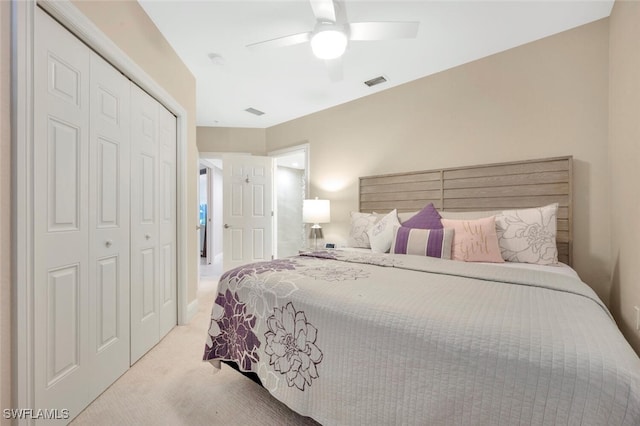 carpeted bedroom with ceiling fan and a closet