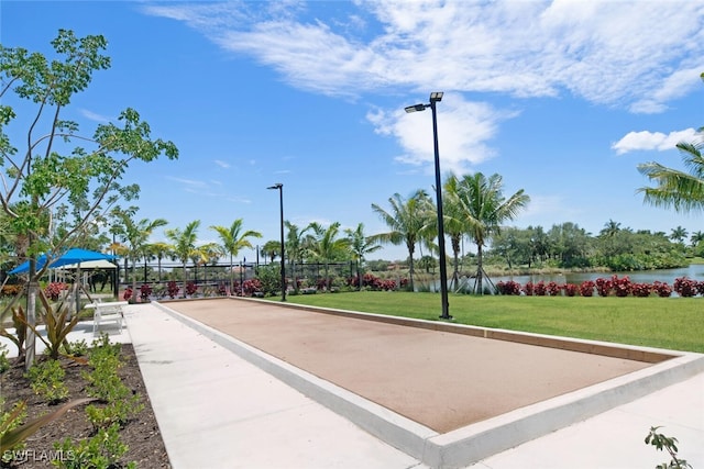 view of property's community featuring a yard and a water view