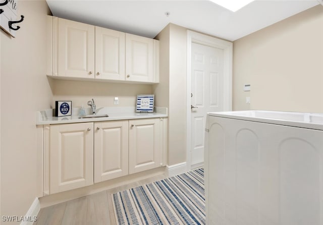 laundry room with washer / clothes dryer, cabinets, and sink