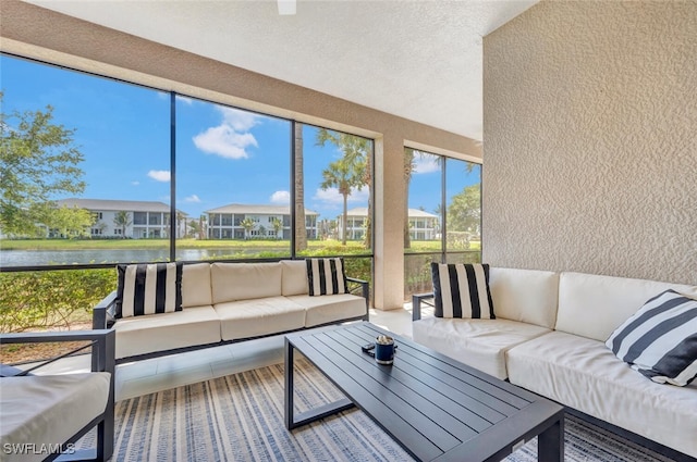 sunroom featuring a water view