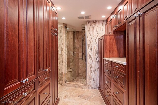 bathroom with vanity and a shower with shower door