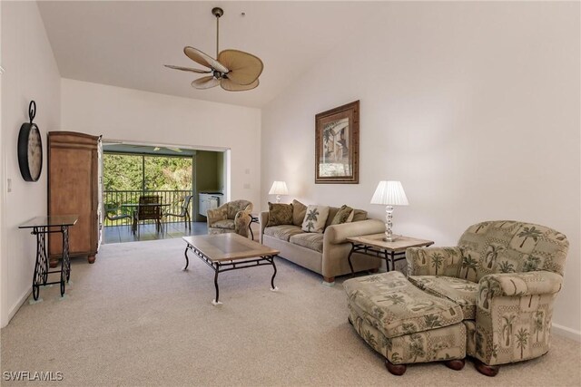 carpeted living room with lofted ceiling and ceiling fan