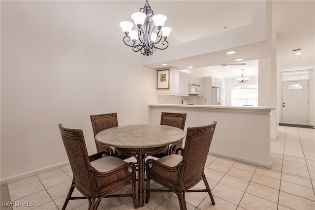 tiled dining room featuring a chandelier