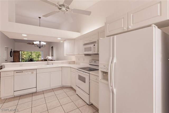 kitchen with ceiling fan with notable chandelier, white appliances, white cabinetry, sink, and light tile patterned flooring