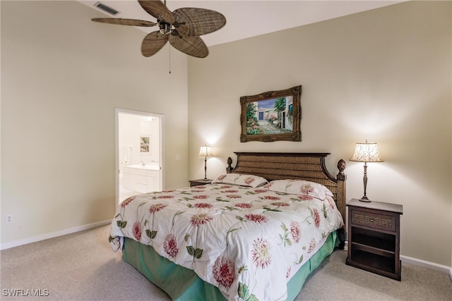 carpeted bedroom with ceiling fan and connected bathroom