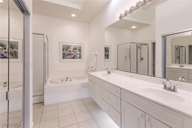 bathroom featuring vanity, independent shower and bath, and tile patterned flooring