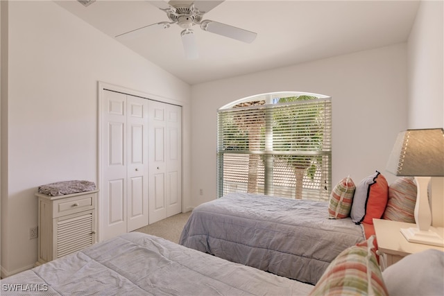 bedroom with multiple windows, ceiling fan, a closet, and light carpet