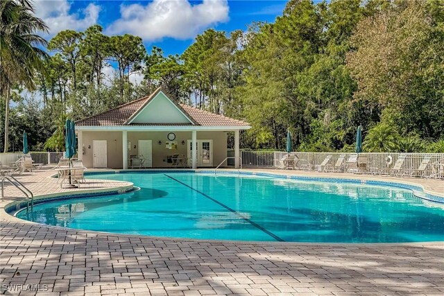 view of swimming pool with an outbuilding and a patio