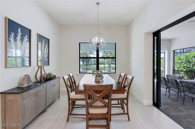 dining space with an inviting chandelier and baseboards