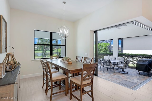 dining space featuring a chandelier, plenty of natural light, and baseboards