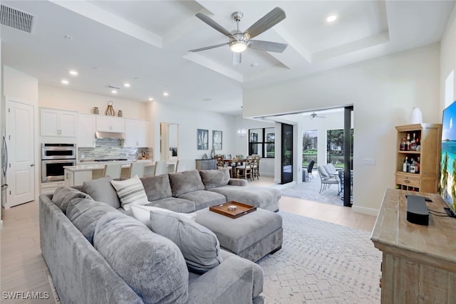 living room featuring visible vents, coffered ceiling, ceiling fan, light wood-type flooring, and recessed lighting