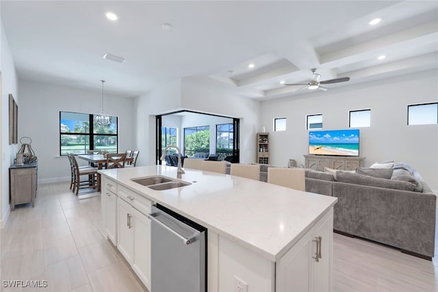 kitchen with stainless steel dishwasher, open floor plan, white cabinetry, a sink, and coffered ceiling