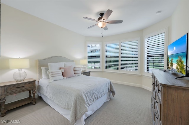 carpeted bedroom featuring a ceiling fan and baseboards