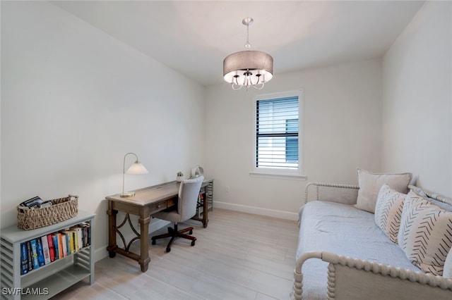 office area featuring baseboards and a chandelier