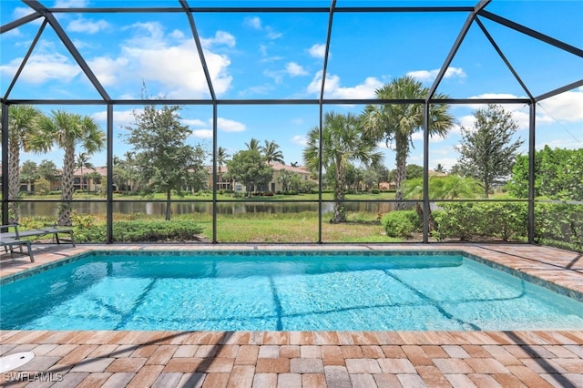 outdoor pool featuring a lanai, a water view, and a patio