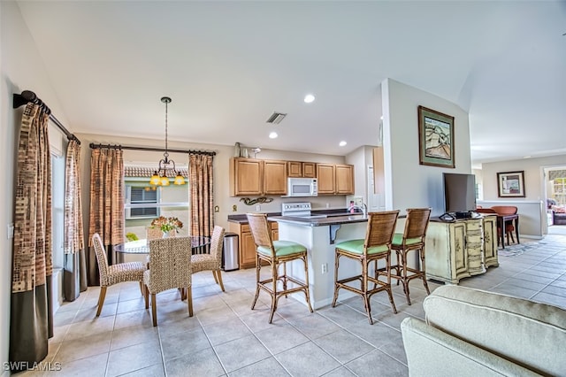 dining area featuring light tile patterned floors and a chandelier