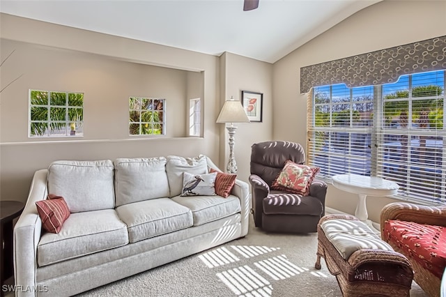 carpeted living room featuring ceiling fan, lofted ceiling, and plenty of natural light