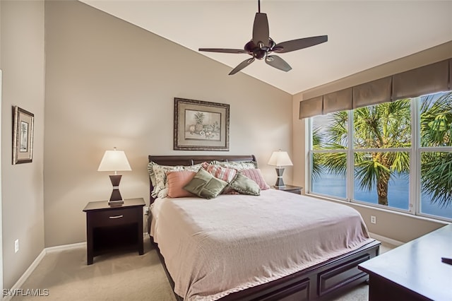 bedroom with ceiling fan, light colored carpet, and lofted ceiling