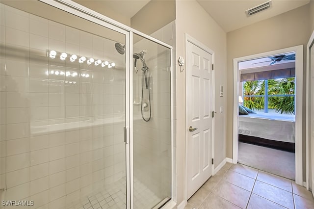 bathroom with tile patterned flooring and a shower with shower door