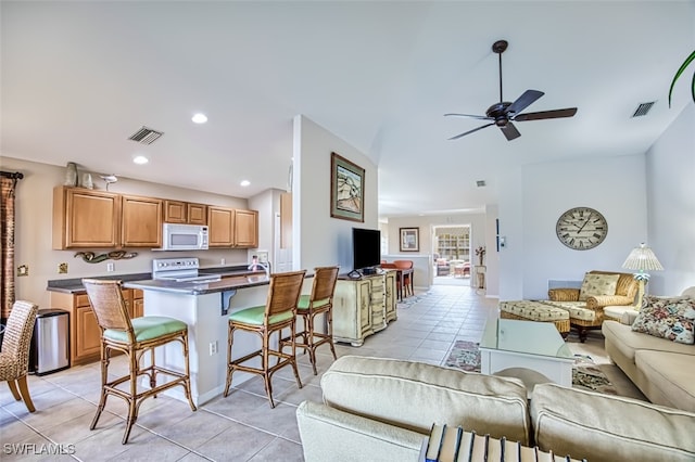 interior space featuring ceiling fan and light tile patterned flooring