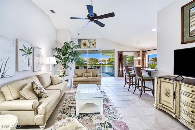 tiled living room with lofted ceiling and ceiling fan