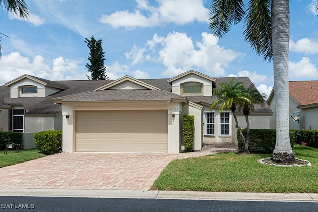 25202 Golf Lake Cir, Bonita Springs, FL 34135 - view of front of property with driveway, a garage, a front yard, stucco siding, and a shingled roof