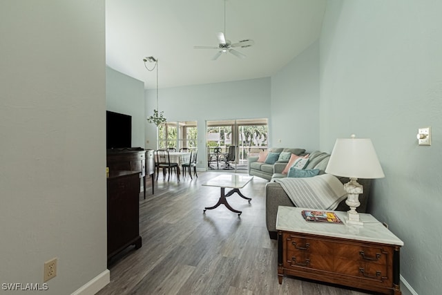 living room featuring ceiling fan, high vaulted ceiling, and dark hardwood / wood-style flooring