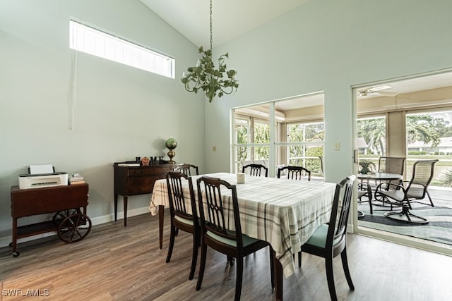 dining area featuring high vaulted ceiling, ceiling fan, and hardwood / wood-style flooring