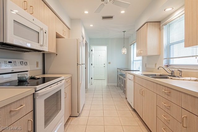 kitchen featuring white appliances, pendant lighting, sink, light brown cabinets, and ceiling fan