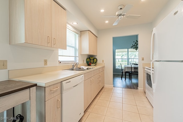 kitchen with white appliances, a wealth of natural light, and light brown cabinets