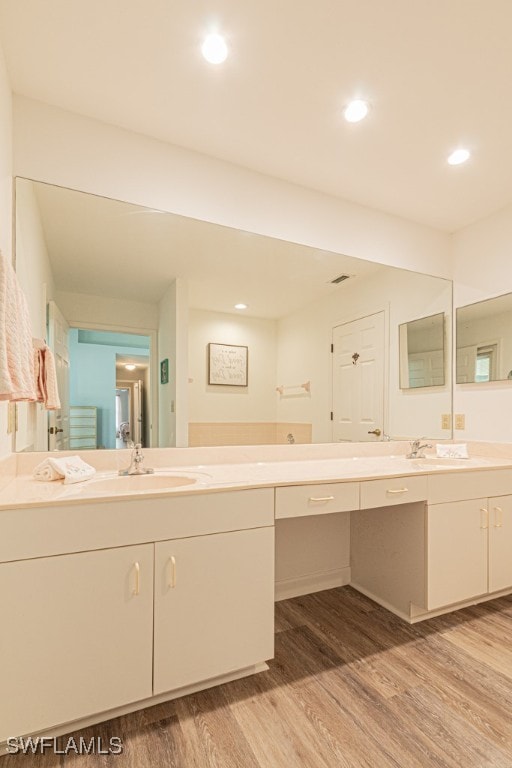 bathroom featuring vanity and hardwood / wood-style floors