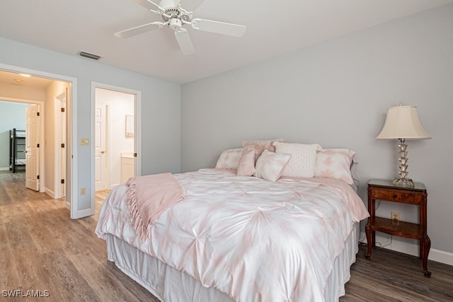 bedroom featuring ensuite bath, hardwood / wood-style floors, and ceiling fan