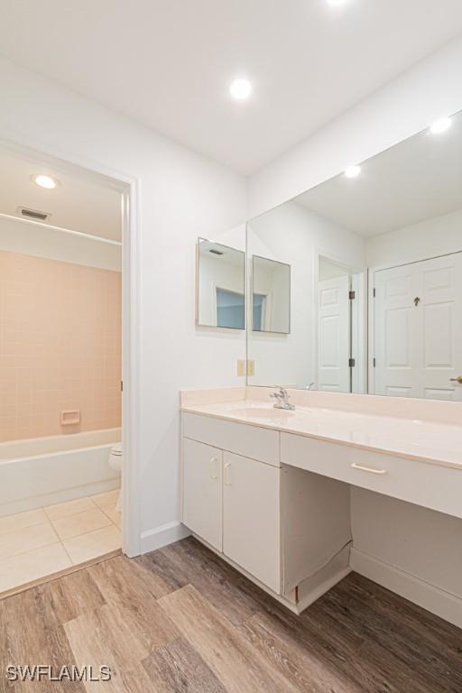 25202 Golf Lake Cir, Bonita Springs, FL 34135 - bathroom featuring vanity, toilet, baseboards, visible vents, and wood finished floors