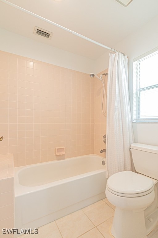 bathroom featuring toilet, tile patterned floors, and shower / bathtub combination with curtain