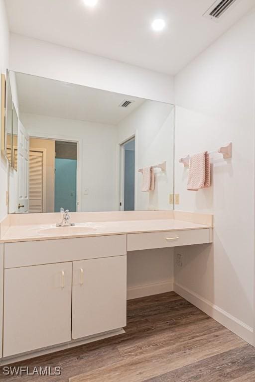 25202 Golf Lake Cir, Bonita Springs, FL 34135 - bathroom featuring visible vents, wood finished floors, and vanity