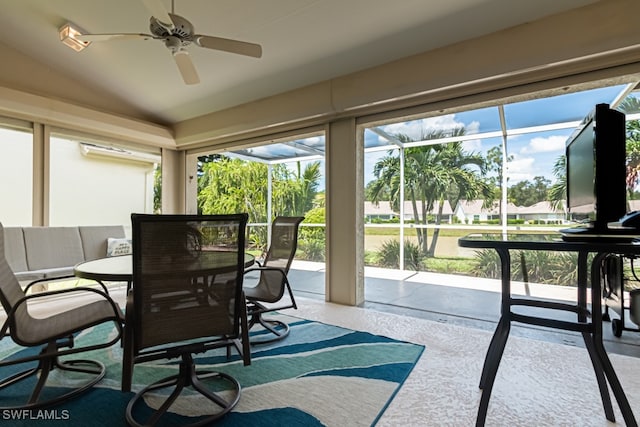 sunroom featuring lofted ceiling and ceiling fan