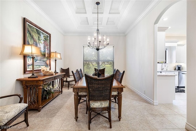 dining area with light tile patterned floors, arched walkways, coffered ceiling, ornamental molding, and a chandelier